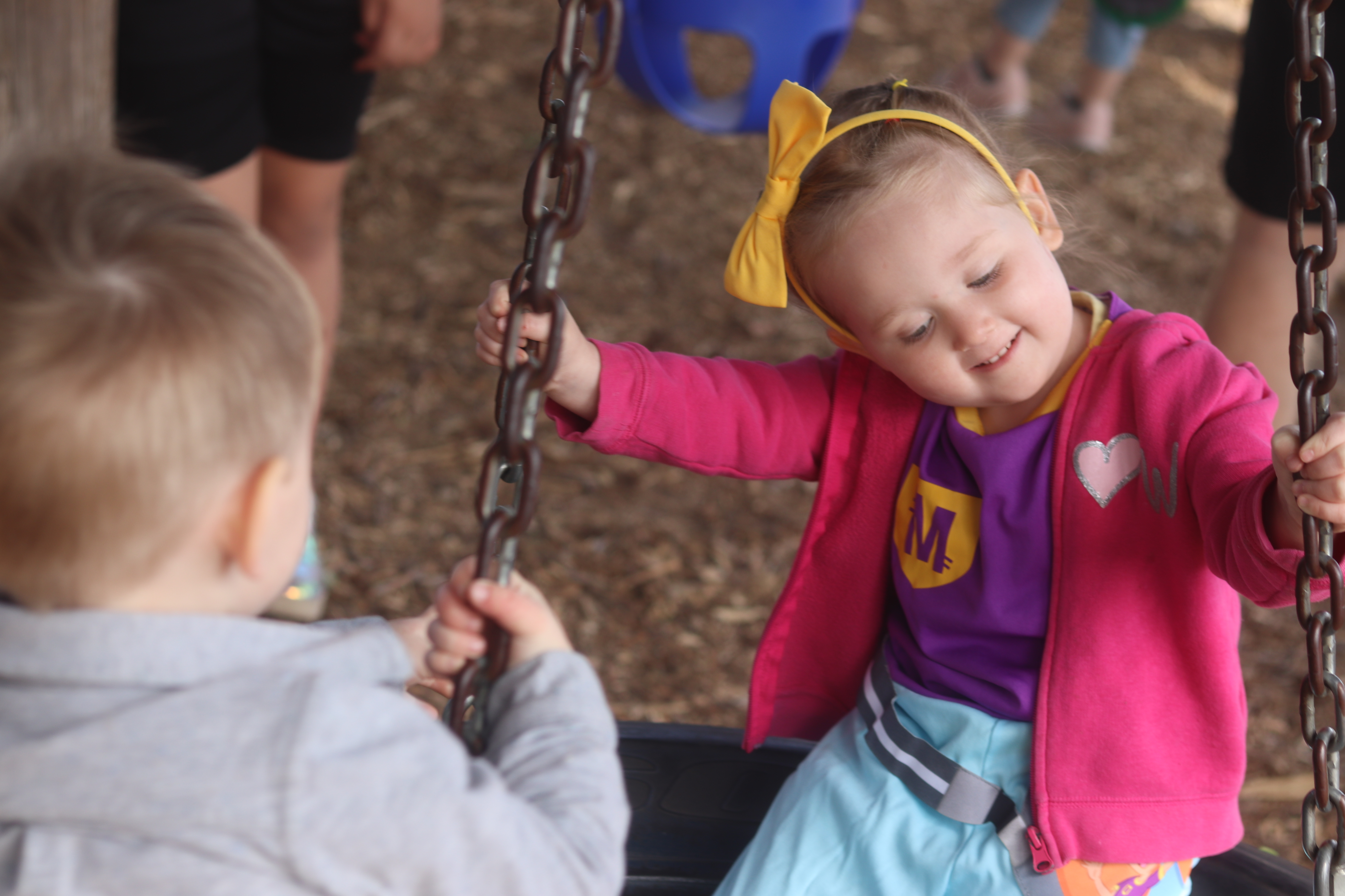 Picture of 4 year old girl on a tire swing.